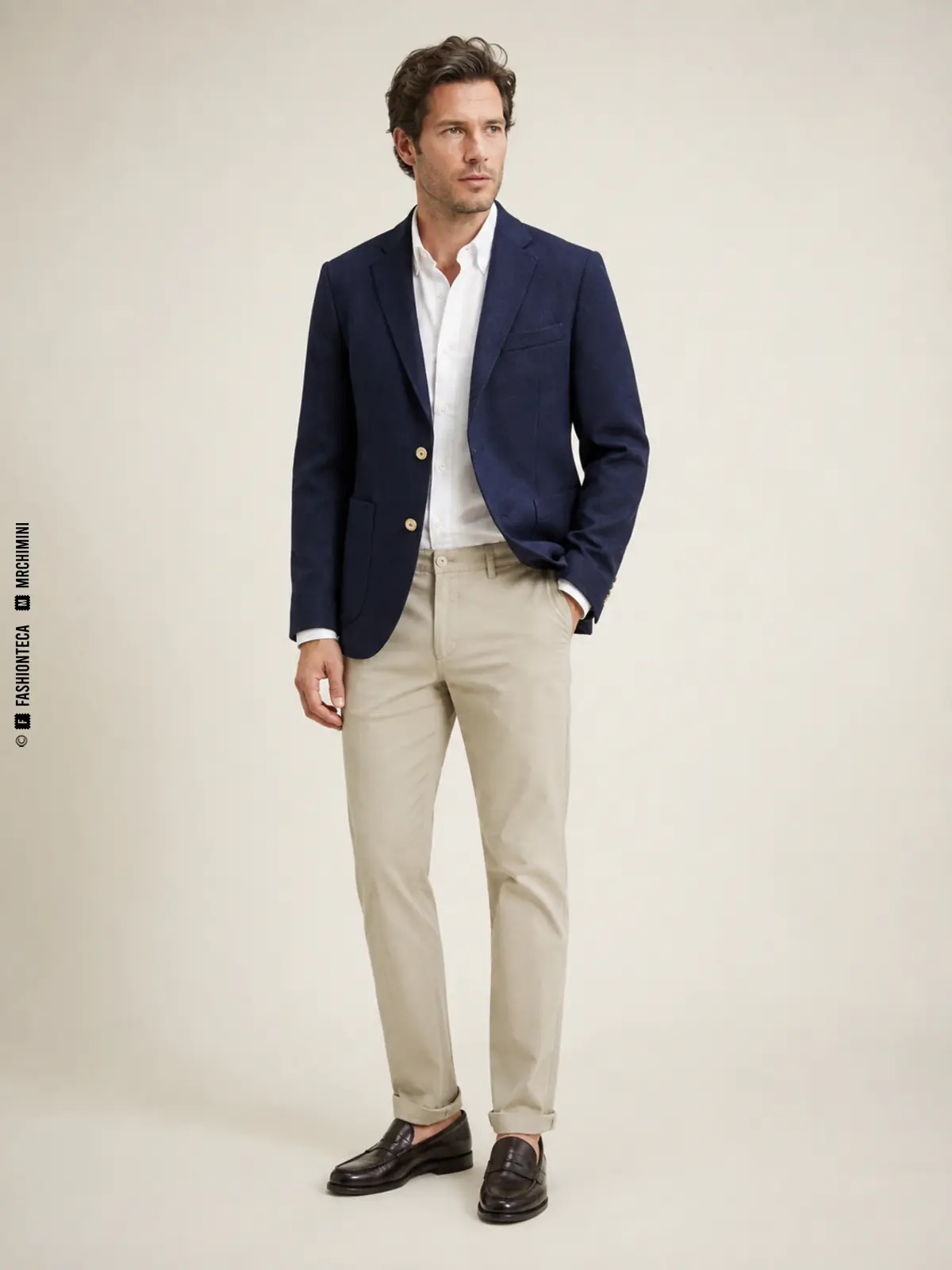 hombre con blazer azul marino de botones metálicos y pantalón claro